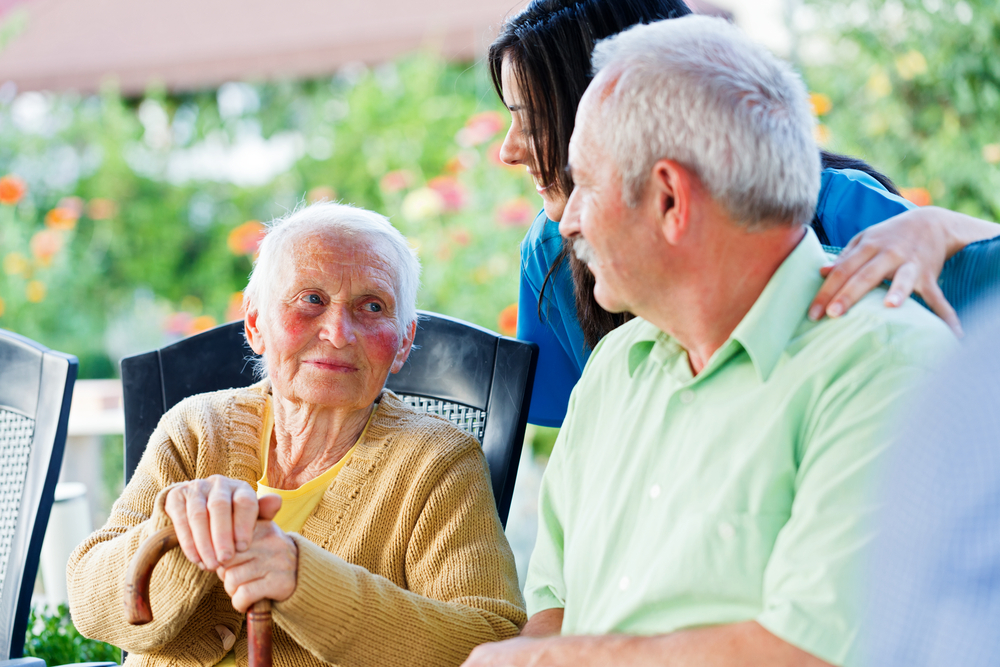 caregiver spending time with elderly couple
