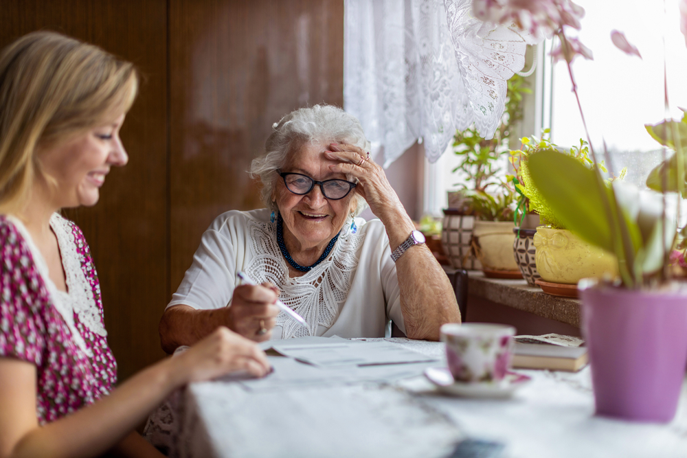 elderly woman talking to caregiver