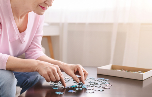 senior dementia patient playing with puzzle pieces