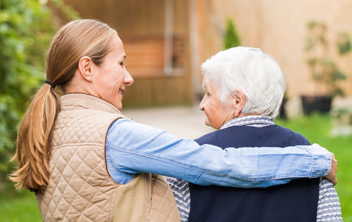 caregiver holding senior with dementia